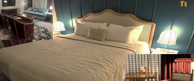 The Raphael guestroom with upholstered headboard and teal walls
